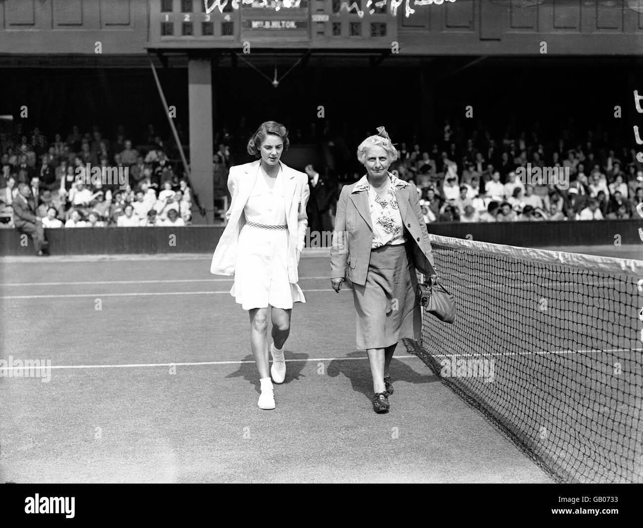 (L-R) Kay Menzies and Hazel Wightman, the donor of the Wightman Cup, walk onto centre court Stock Photo