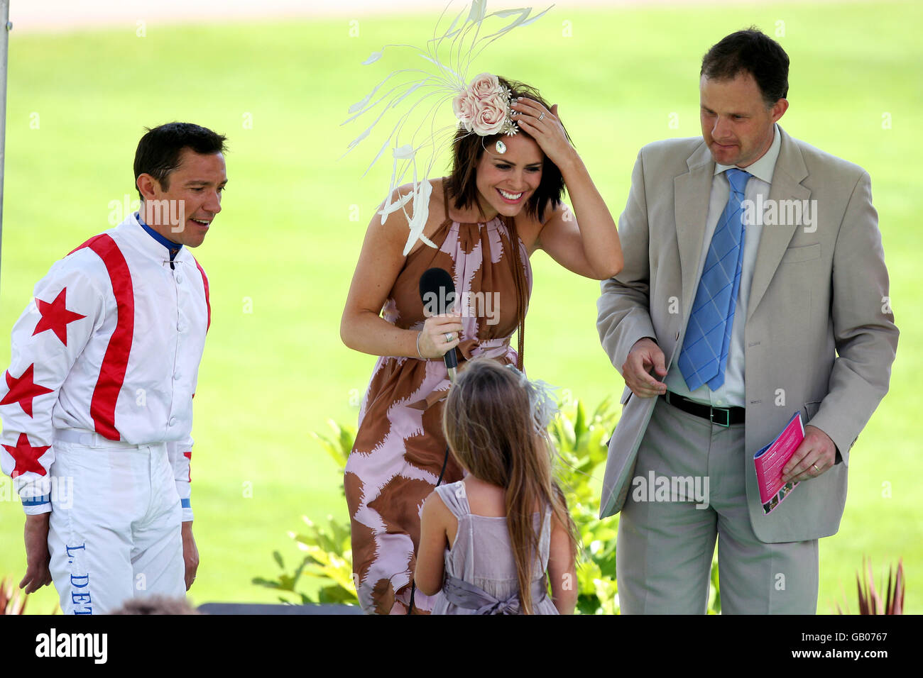Actress and model Susie Amy (l) and TV presenter Sarah Jagger (r) introduce jockey Frankie Dettori as they prepare to present the awards for best dressed at Sandown Park Stock Photo
