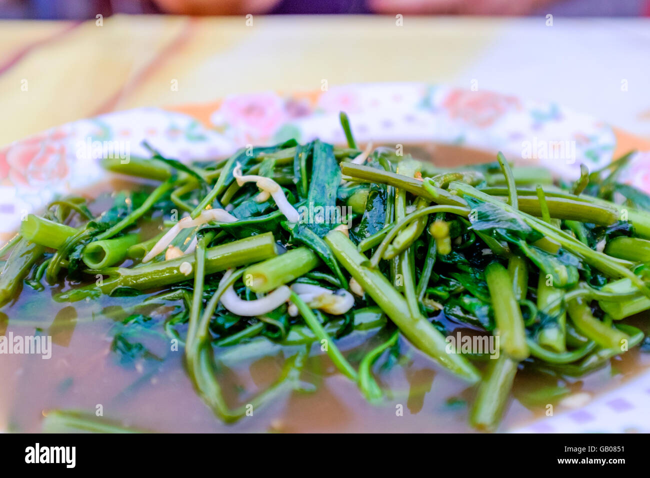 Plate of stir fried green veg,Morning Glory,Thai food market,Chiang Mai Thailand Stock Photo