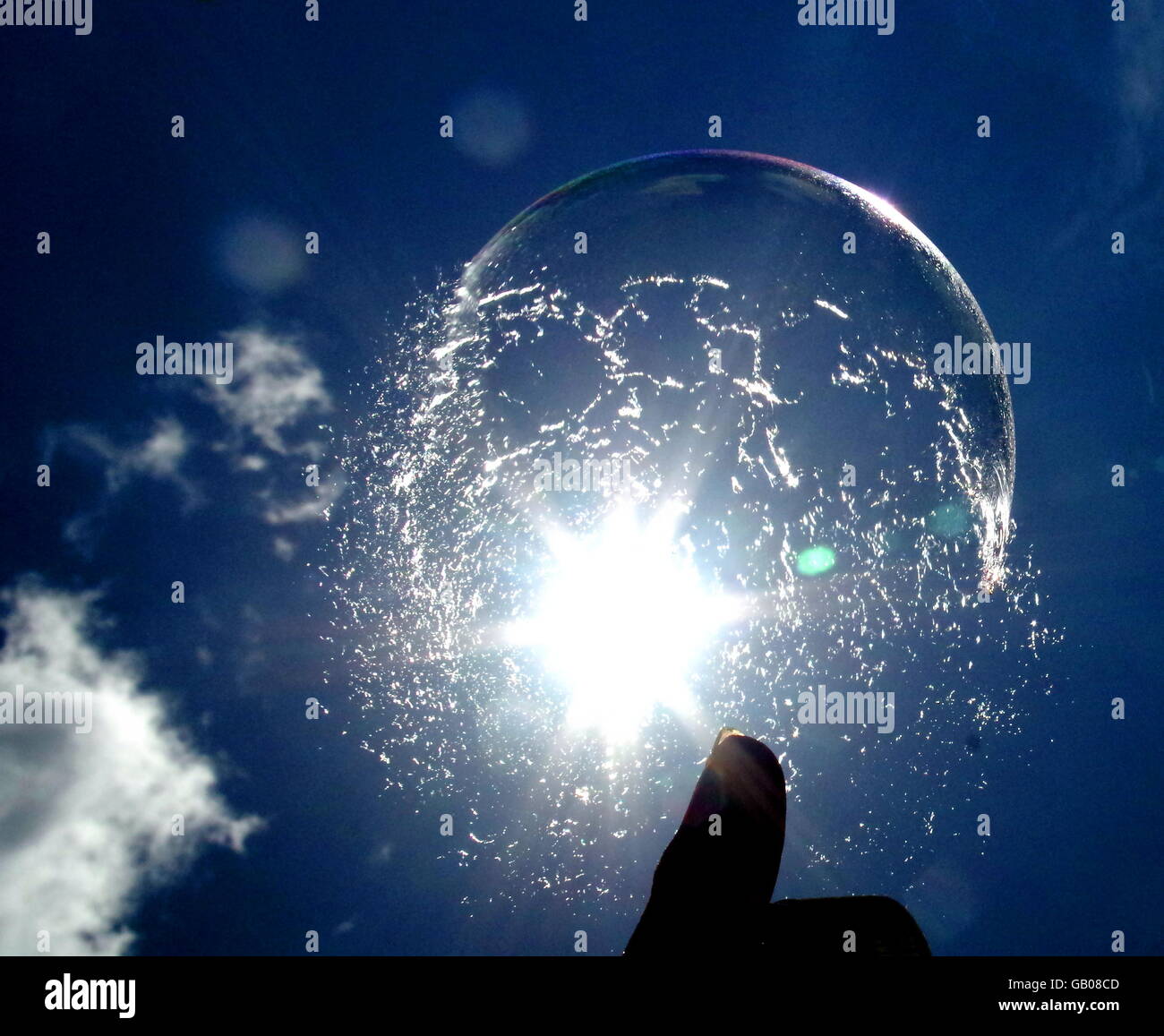 Bubble bursting on fingertip Stock Photo