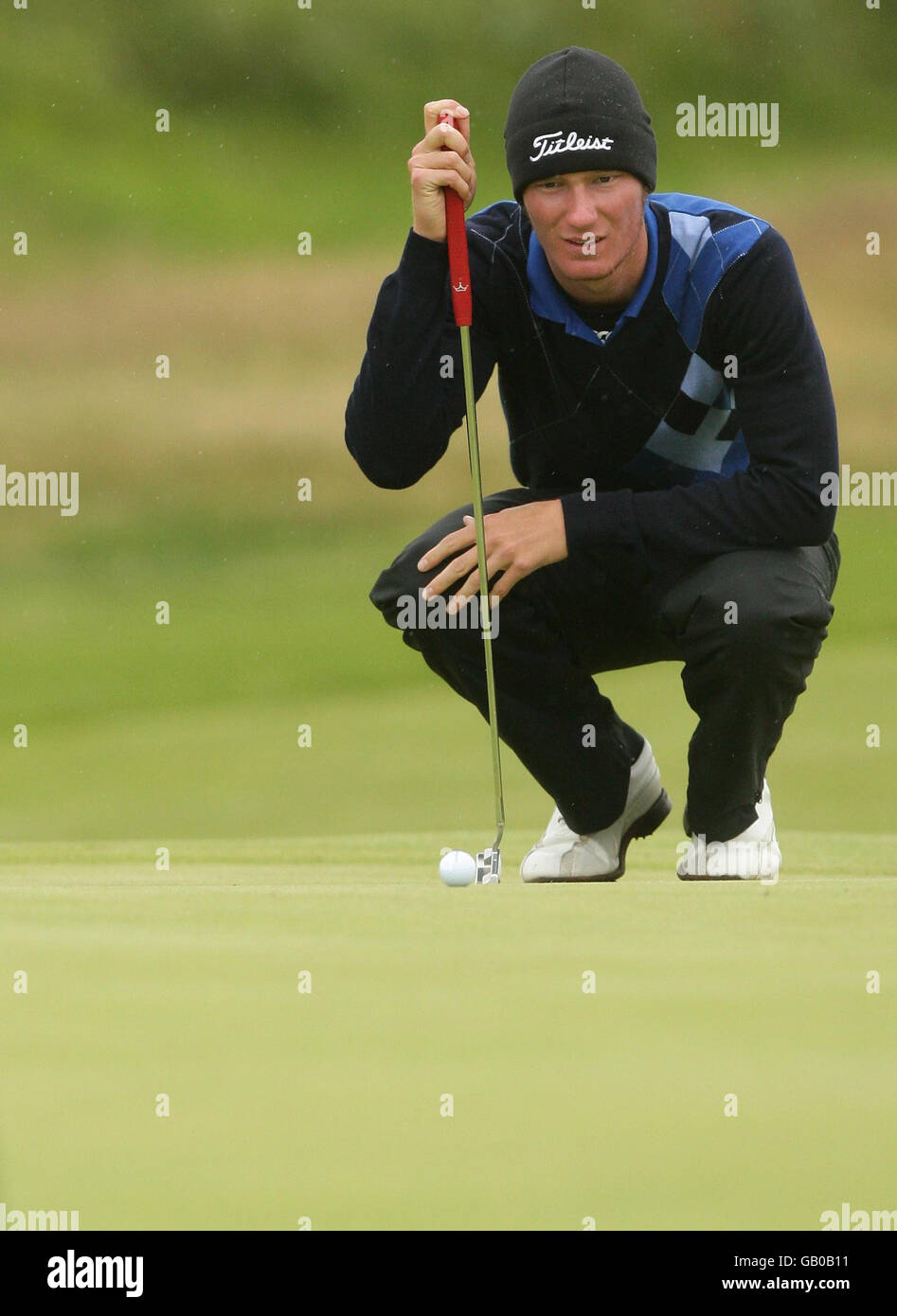 English amateur Chris Wood lines up a putt on the 8th hole during Round One of the Open Championship at the Royal Birkdale Golf Club, Southport. Stock Photo