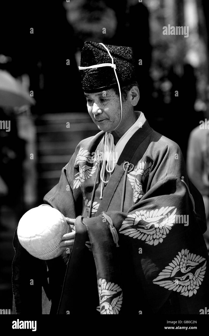 A Kemari player holds the deerskin-covered ball, stuffed with sawdust and tied together with horse skin Stock Photo