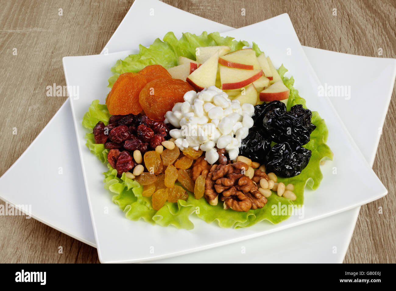 Vitamin salad with nuts, apples, dried fruit and cottage cheese in