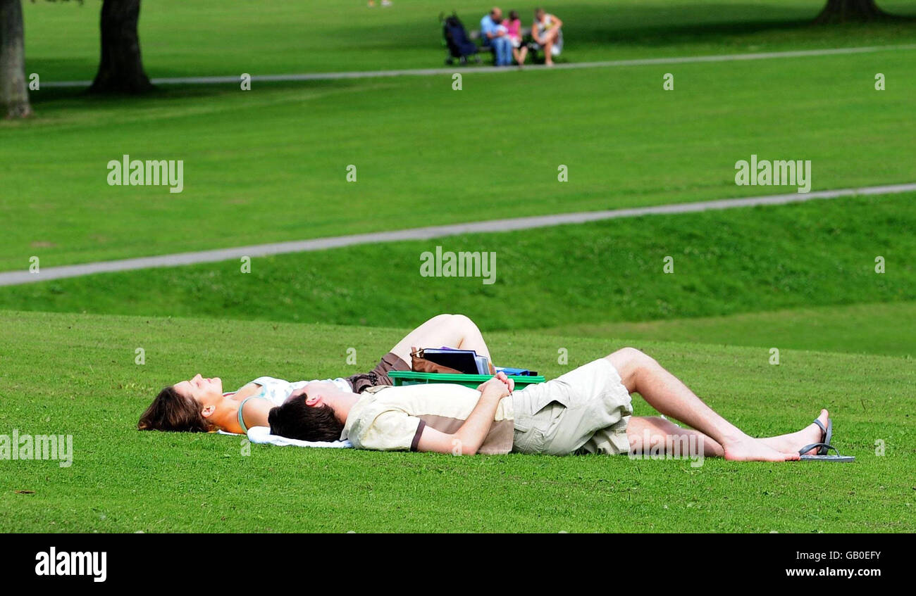 Sunbathers enjoy the fine weather in Roundhay Park, Leeds. Stock Photo