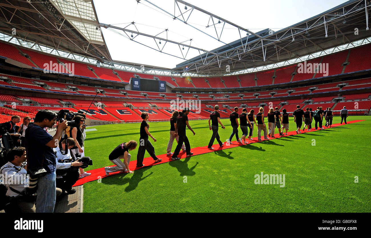 Members of the cast taking part in the London 2012 eight-minute section in the closing ceremony at the Beijing Olympic Games visit Wembley Stadium to familiarise themselves with performing in a large stadium, Wembley, London. PRESS ASSOCIATION Photo. Stock Photo
