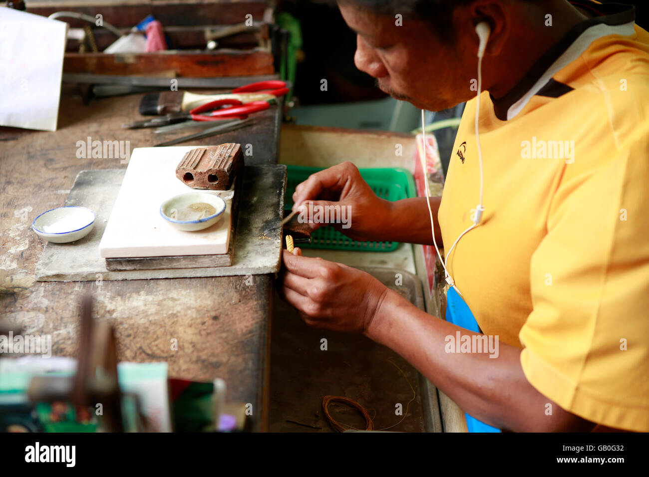Traditional Thai jewelry being made in the Somsak gold factory near Sukhothai Stock Photo