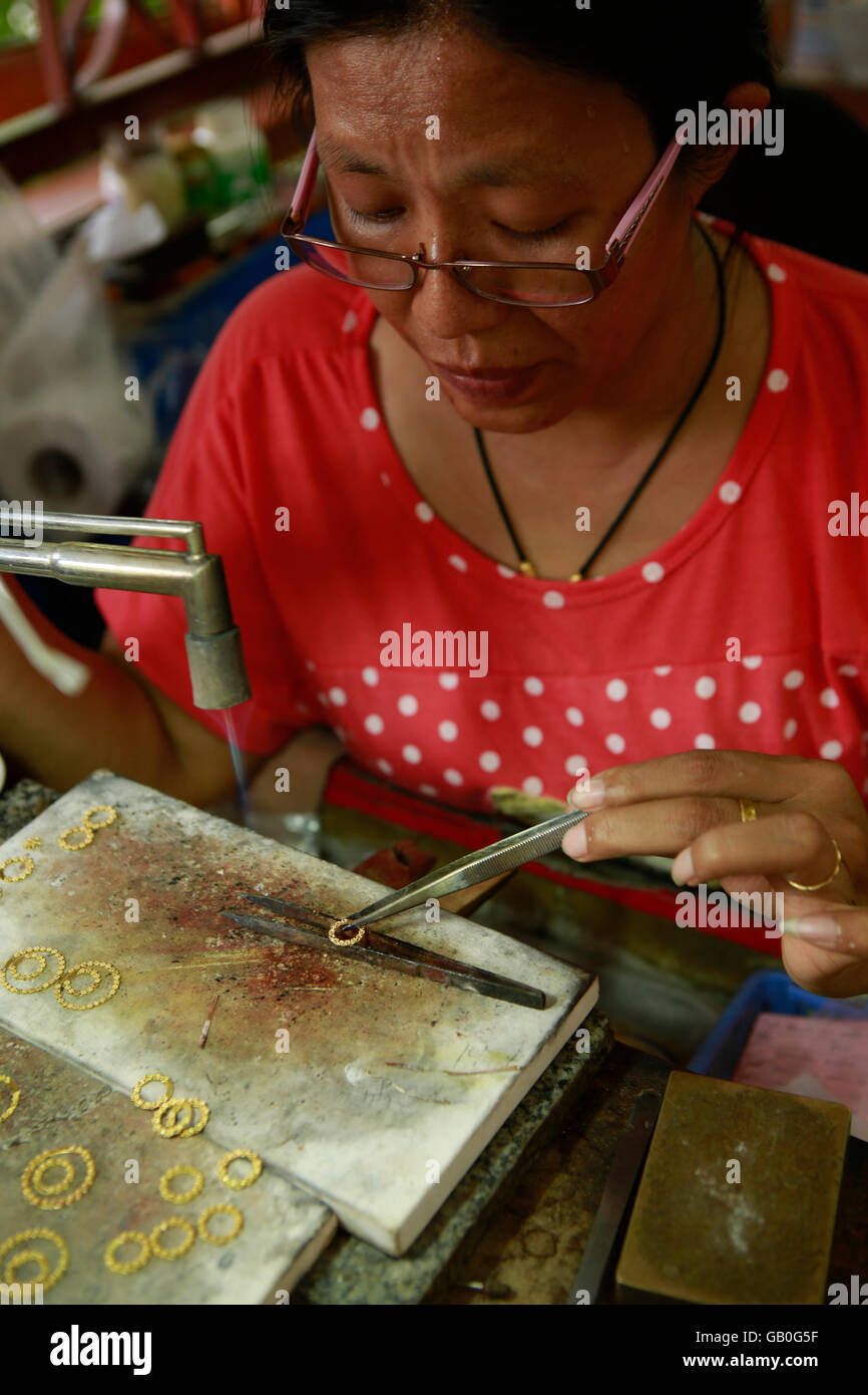 Traditional Thai jewelry being made in the Somsak gold factory near Sukhothai Stock Photo