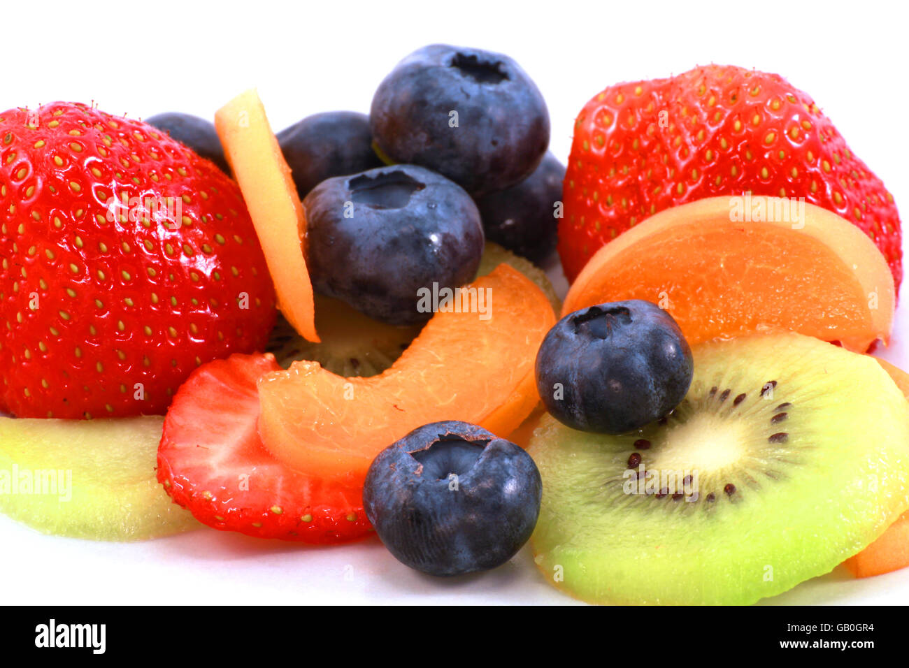 different fruits strawberry, blueberry and apricot, kiwi placed