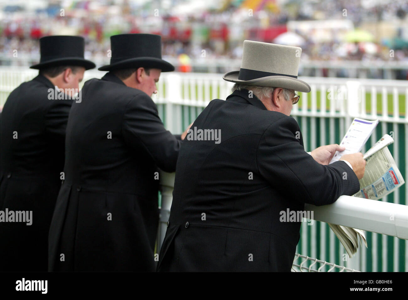 Spectators study the form guide at Epsom on Derby Day Stock Photo - Alamy