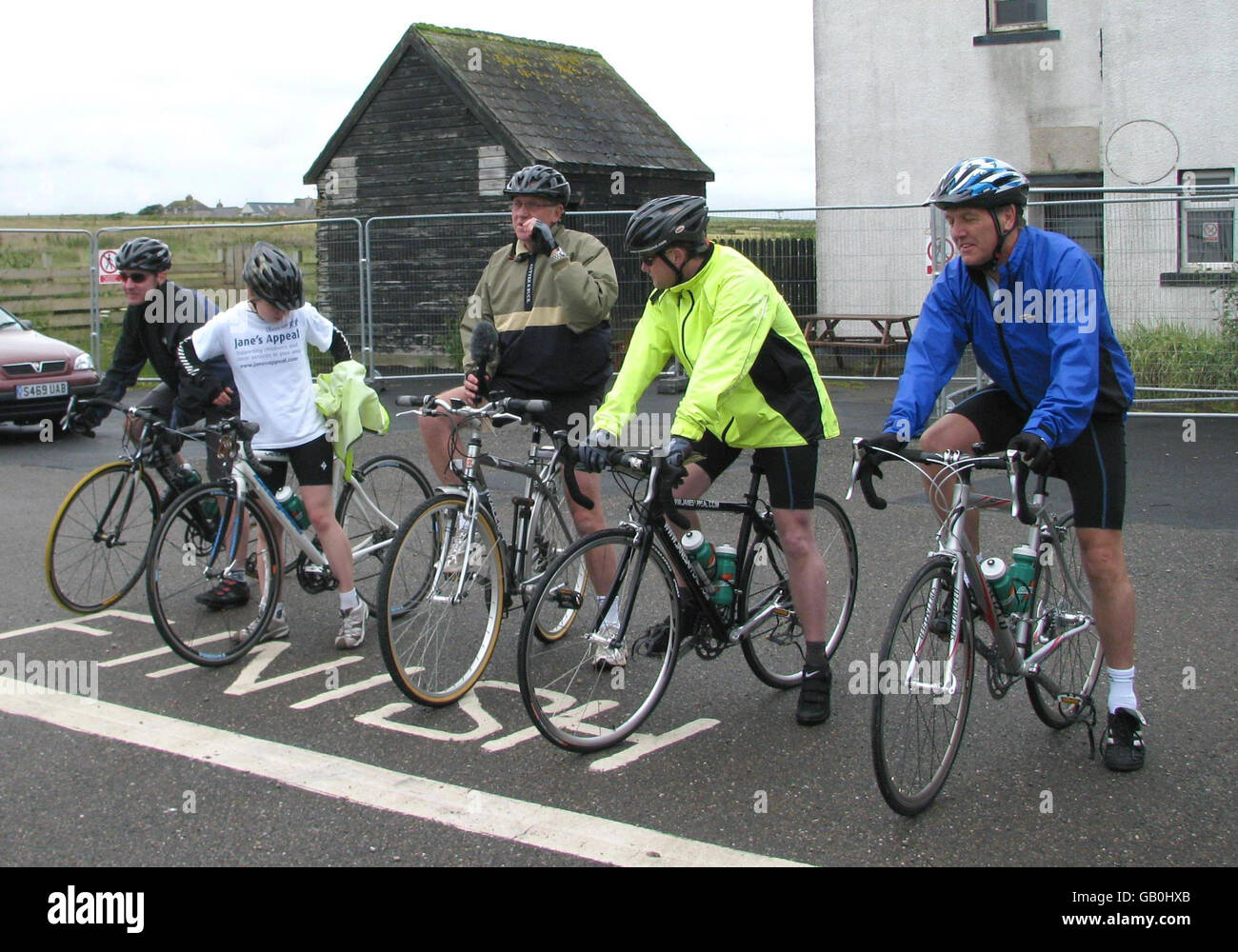 Mike Tomlinson (second right) and daughter Rebecca (second left), the husband and daughter of charity campaigner Jane Tomlinson, at John O'Groats in the north of Scotland as they prepare to cycle the length of Britain to Land's End. Stock Photo