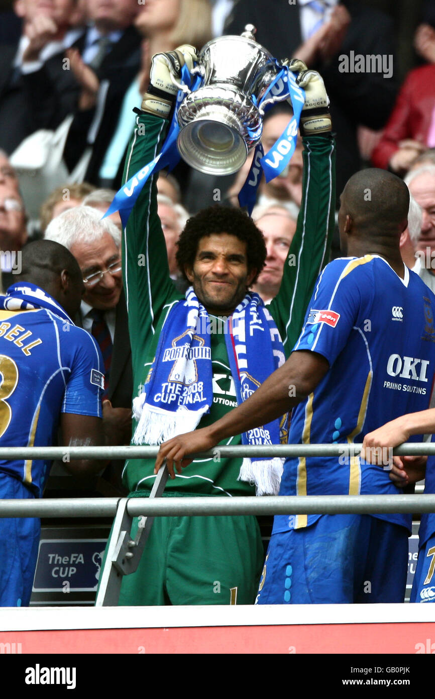 Portsmouth goalkeeper David James (centre) lifts the FA Cup after