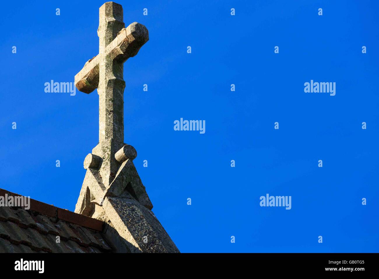 A granite church cross on an spire in St, Ives harbour in Cornwall, UK Stock Photo