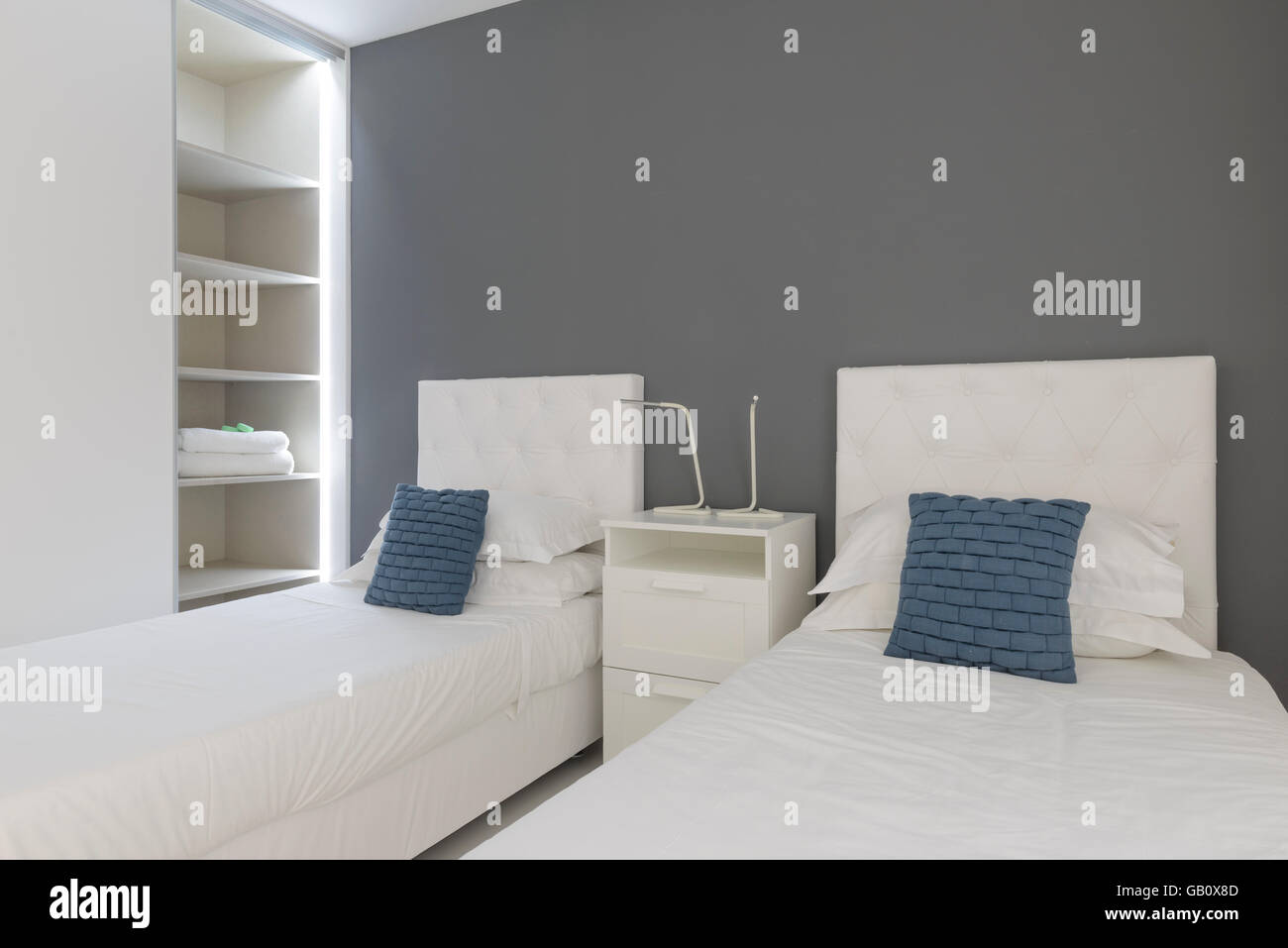Twin beds in hotel room with open closet Stock Photo
