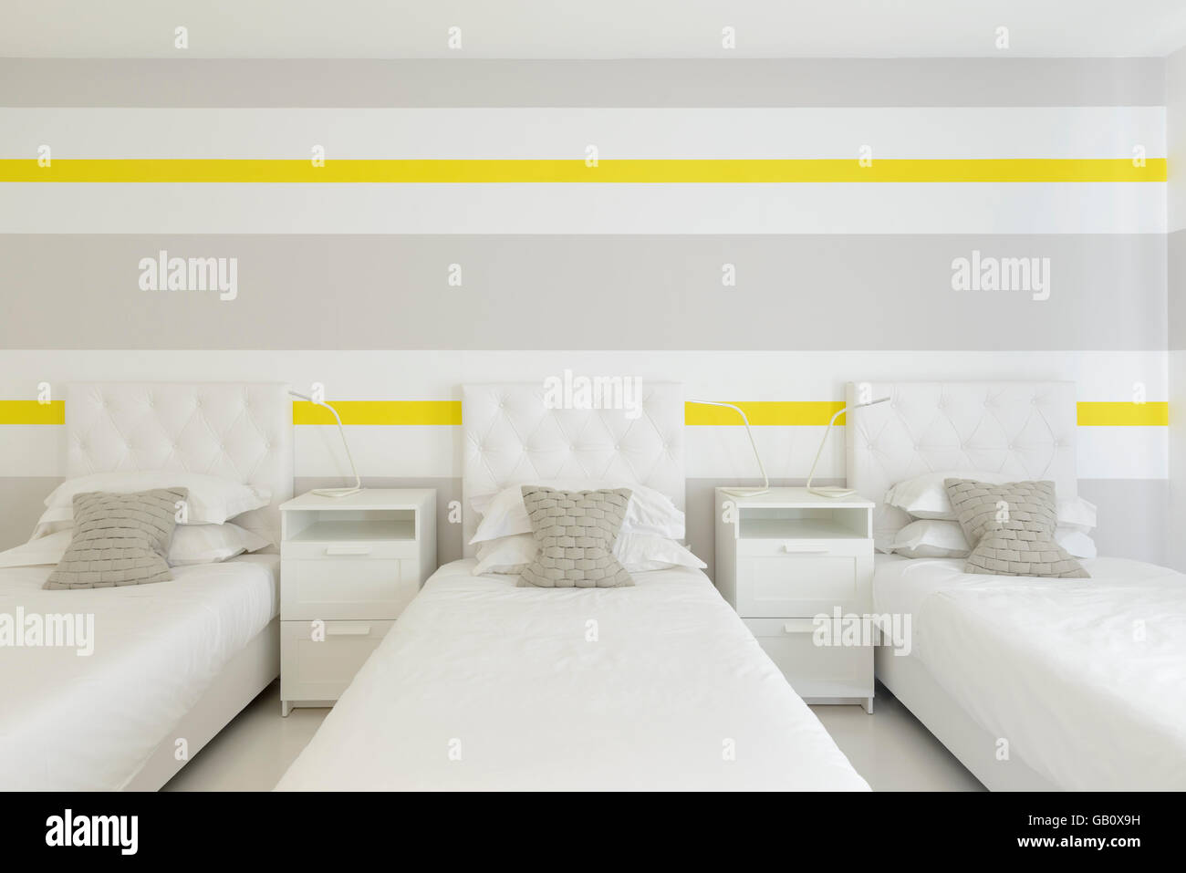 Three beds side by side in an hotel room Stock Photo Alamy