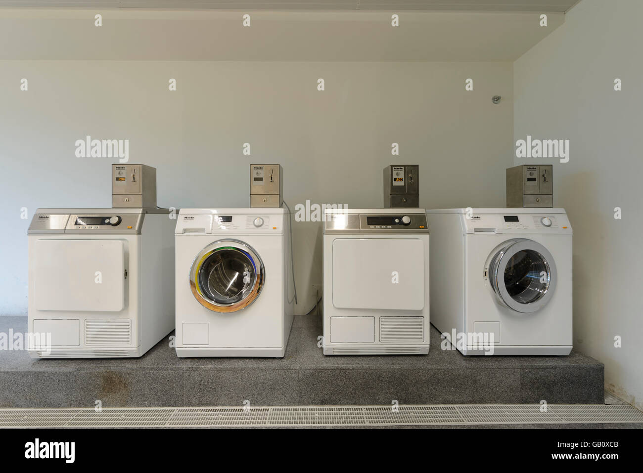 Washing and drying machines at laundrymat Stock Photo