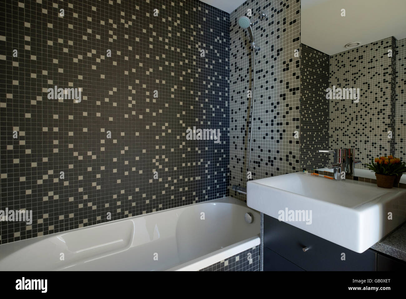 Modern bathroom with dark tiles Stock Photo - Alamy