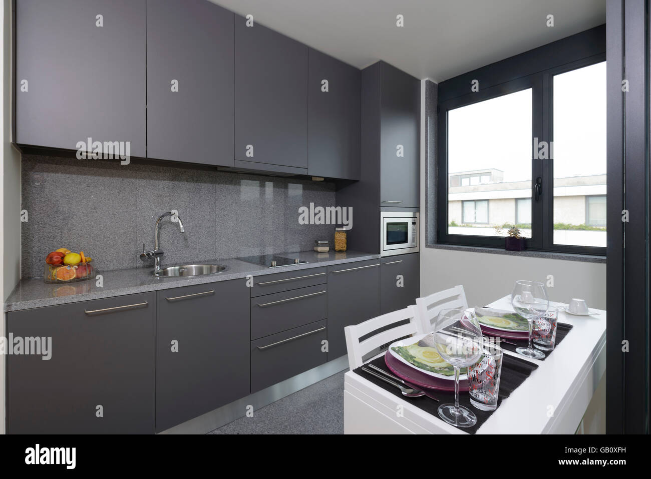 Small Modern Grey Kitchen With Dining Table Stock Photo Alamy