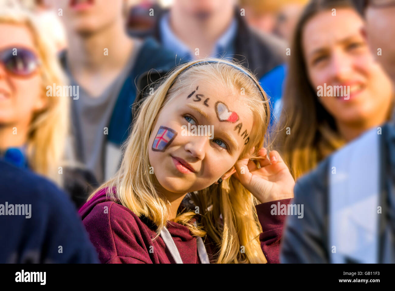 Crowds in Reykjavik watching Iceland in the UEFA Euro 2016 football tournament, Reykjavik, Iceland. Girl with painted face. Stock Photo