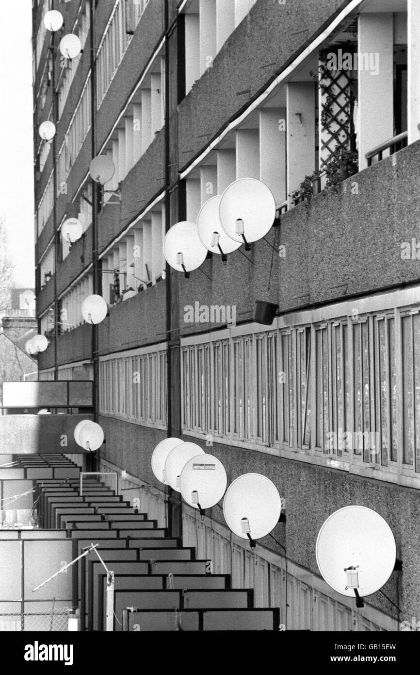 The growing popularity of satellite television is demonstrated by the number of receiving dishes on the side of this south London council estate. Stock Photo