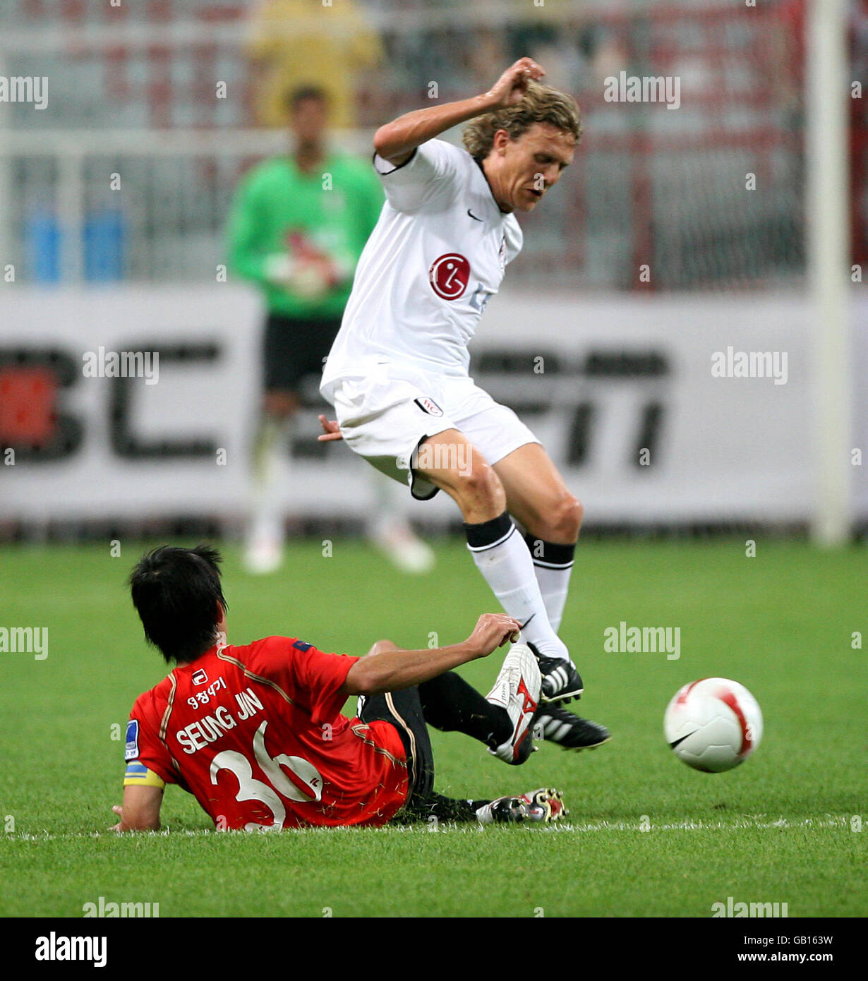 Fulham's Jimmy Bullard (r) evades a challenge by Busan Icons' Joo Seung Jin Stock Photo
