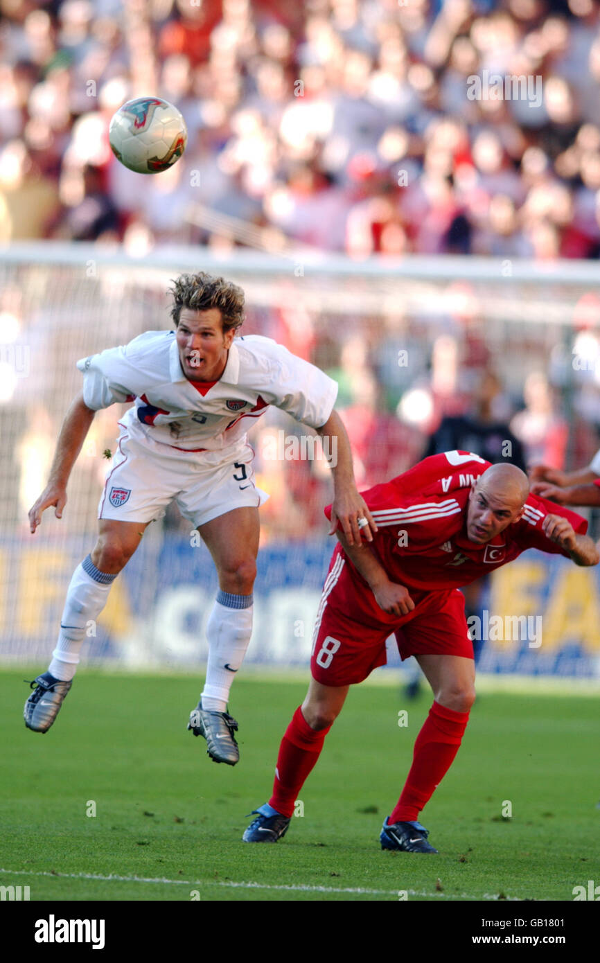 USA's Greg Vanney (l) heads the ball clear from Volkan Arslan (r) of Turkey Stock Photo