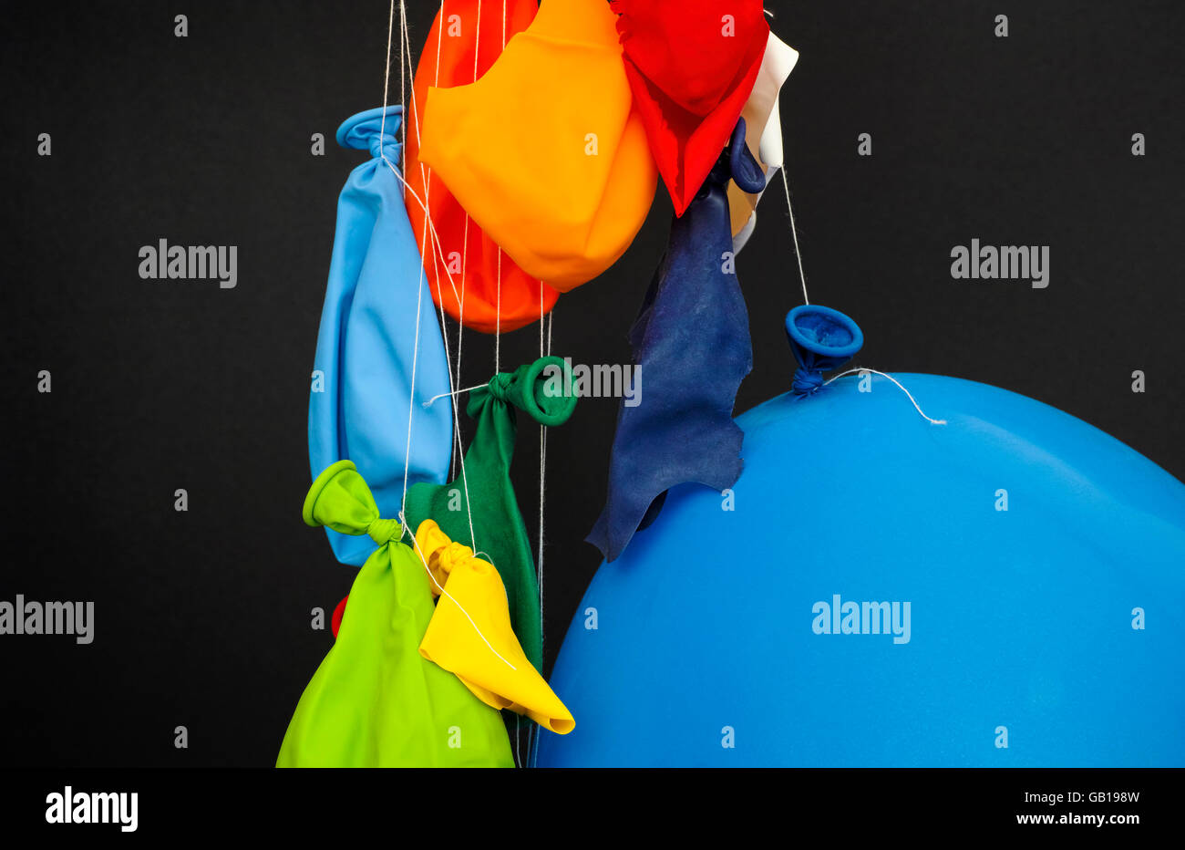 End of the party. Some burst, deflated balloons and one inflated