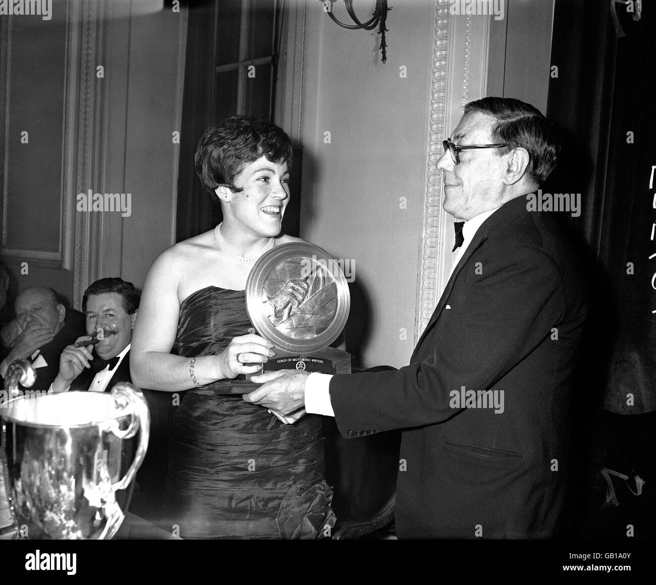 The Vice-President of the Guild of Motoring Writers, Lawrence Wade (r), presents the Driver of the Year trophy to Pat Moss-Carlsson (l) Stock Photo