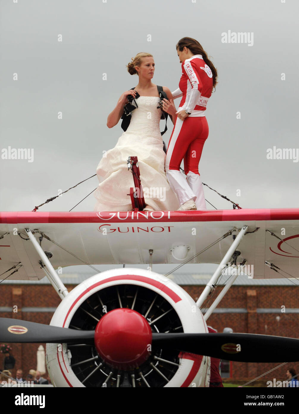 Wedding in the air. Bridge Katie Hodgson is harnessed onto the aircraft before her wingwalk over Gloucestershire. Stock Photo
