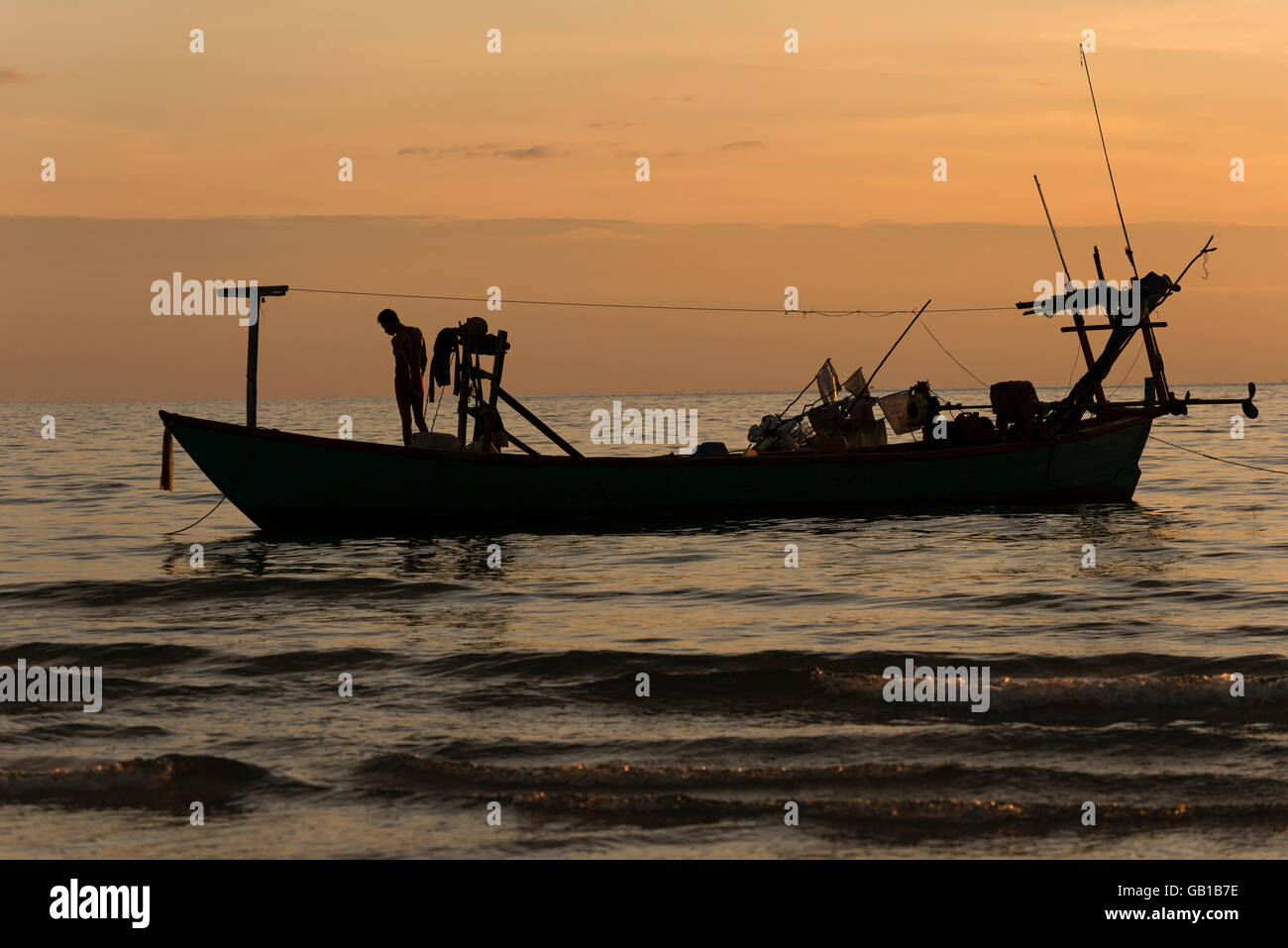 Silhouette of a fishing boat Stock Photo - Alamy