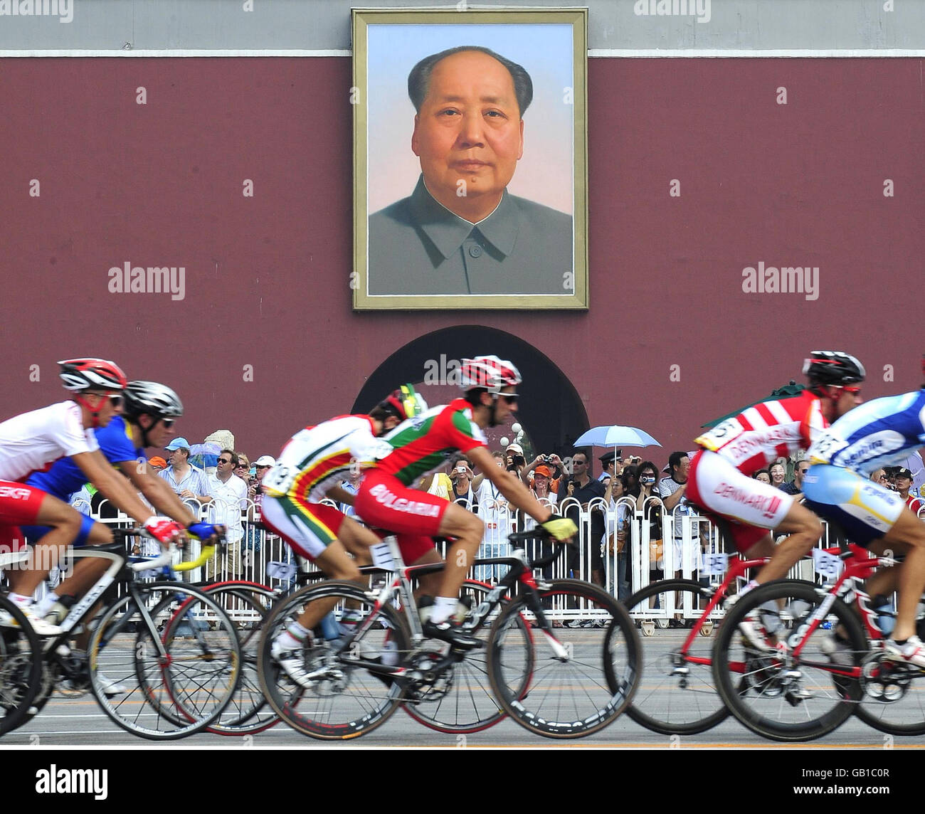 Riders in the Olympics Mens Road Race as competitors pass the portrait ...