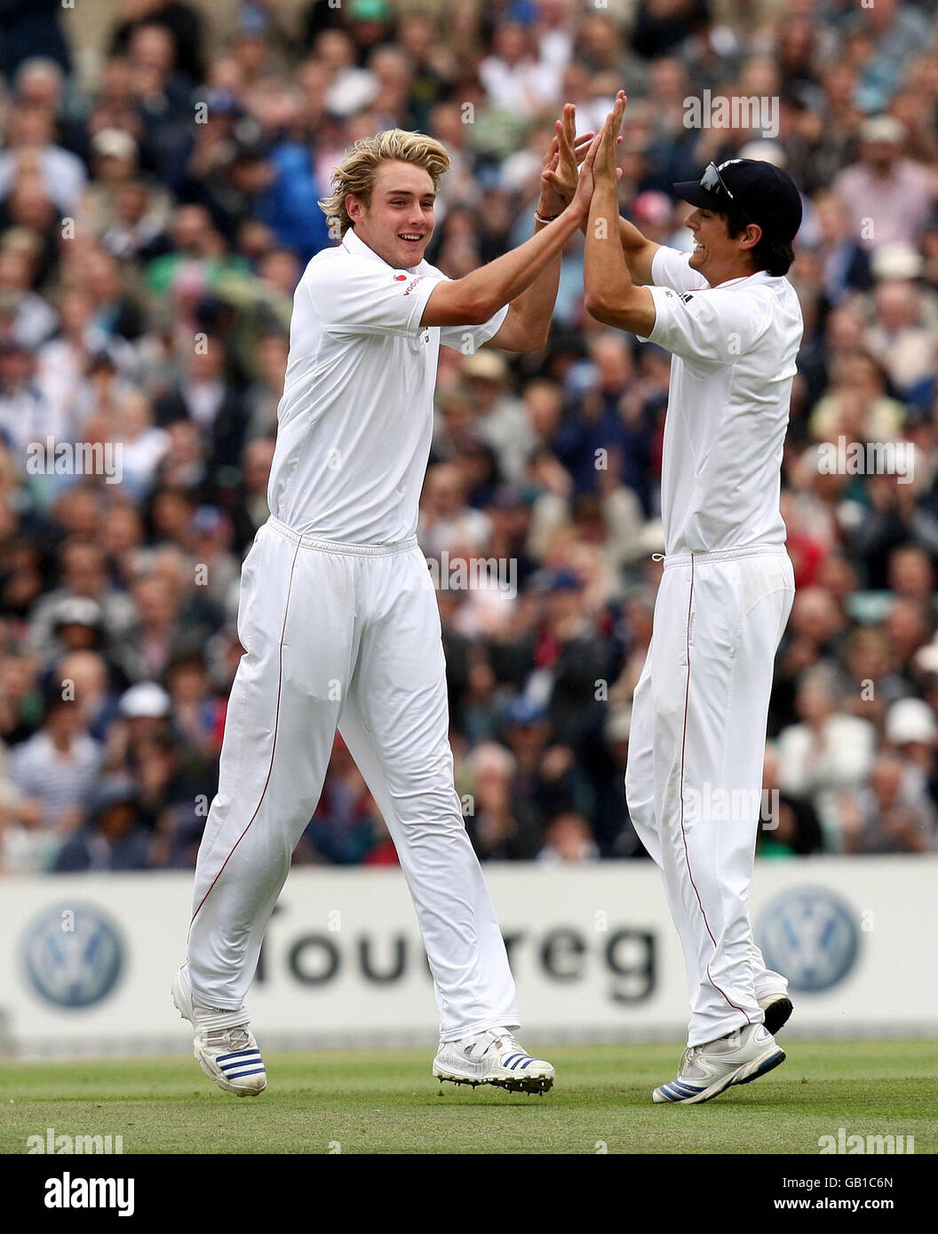 England's Stuart Broad celebrates with Alastair Cook after taking the wicket of South Africa's Neil McKenzie for 29 during the Fourth Test at The Oval in London. Stock Photo