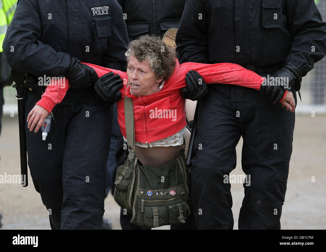 Police officers arrest an environmental protestor close to Kingsnorth power station near Hoo in Kent. Stock Photo