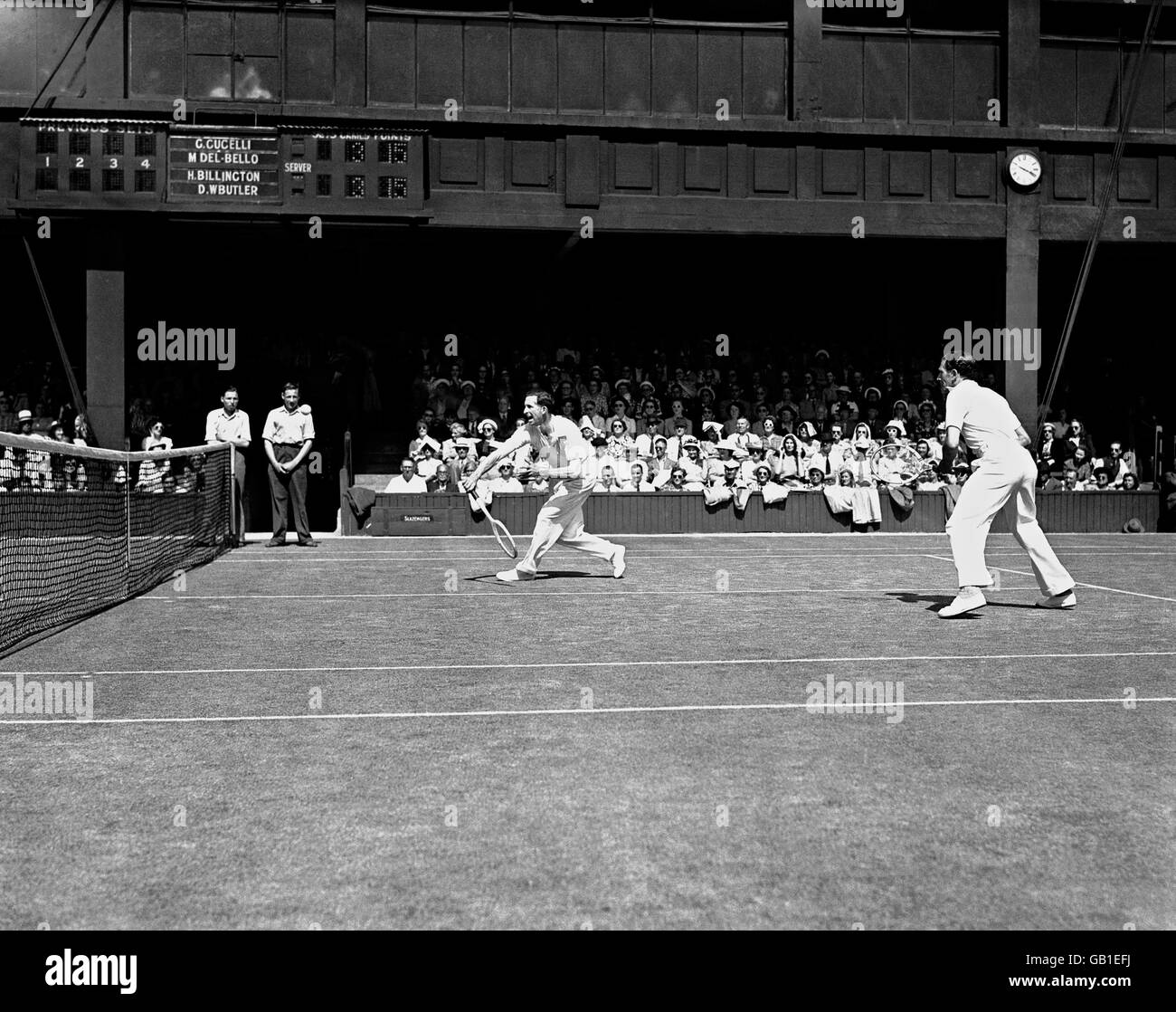 Henry Billington (l) in action with D. W. Butler (r) during the Men's Doubles at Wimbledon. Billington is the Grandfather of Tim Henman Stock Photo