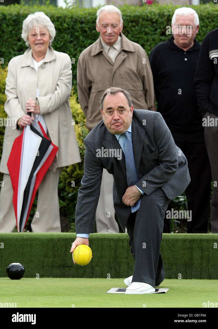 First Minister Alex Salmond plays a shot during a game of bowls while visiting Garrowhill Bowling Club, to highlight support for pensioners in the city's east end. Stock Photo