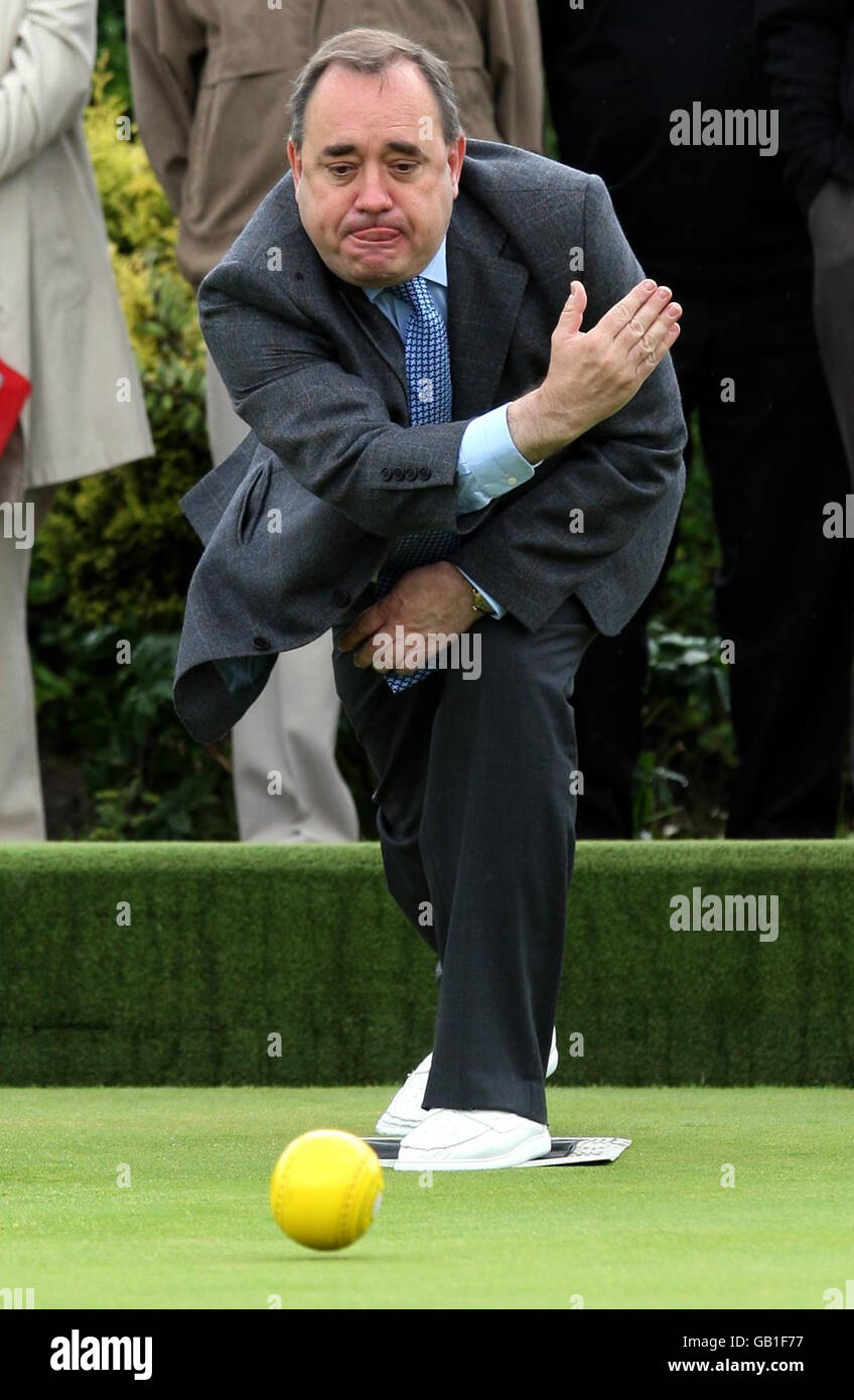 First Minister Alex Salmond plays a shot during a game of bowls while visiting Garrowhill Bowling Club, to highlight support for pensioners in the citys east end. Stock Photo