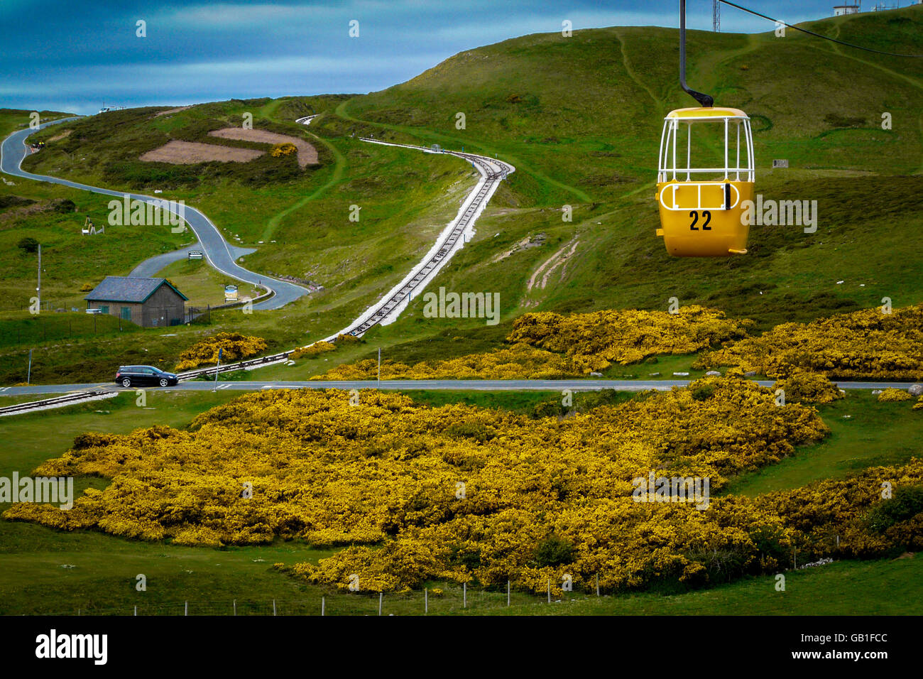 A yellow cable car exactly matches the yellow gorse below it Stock Photo