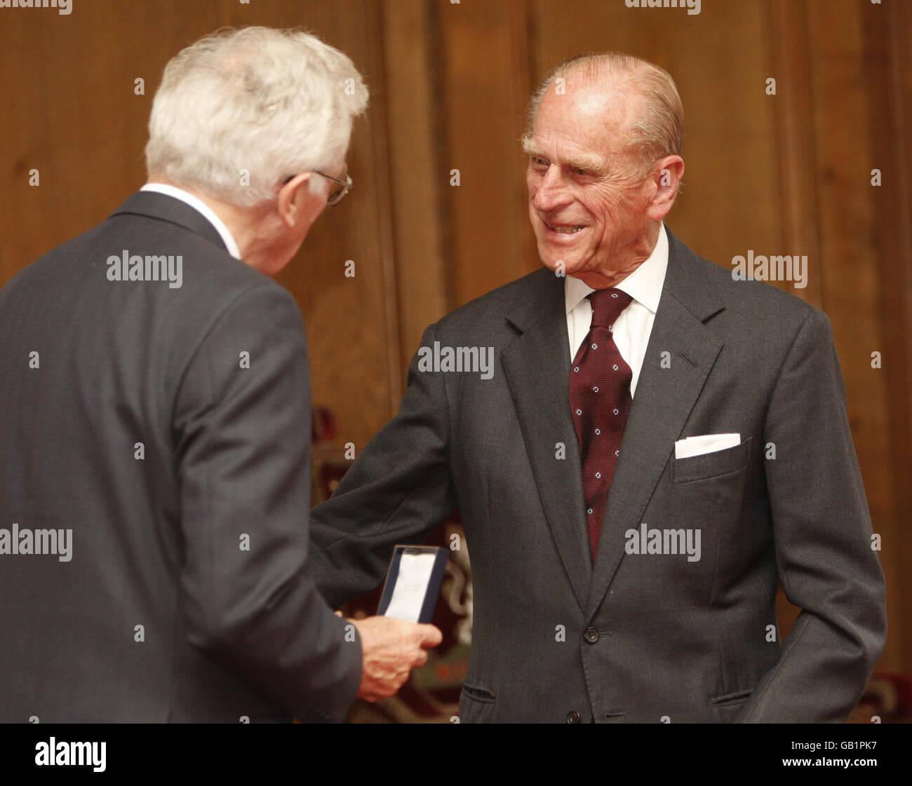 The Duke of Edinburgh presents Professor Roger Fletcher with a Royal