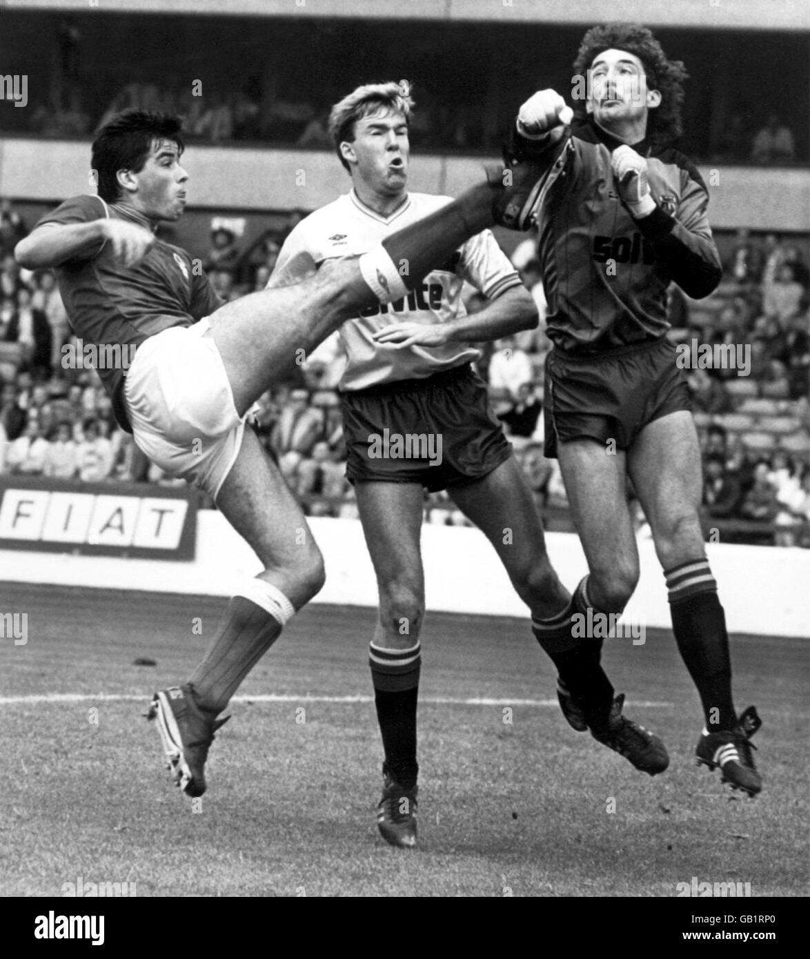 Watford goalkeeper Tony Coton (r) punches clear from Nottingham Forest 