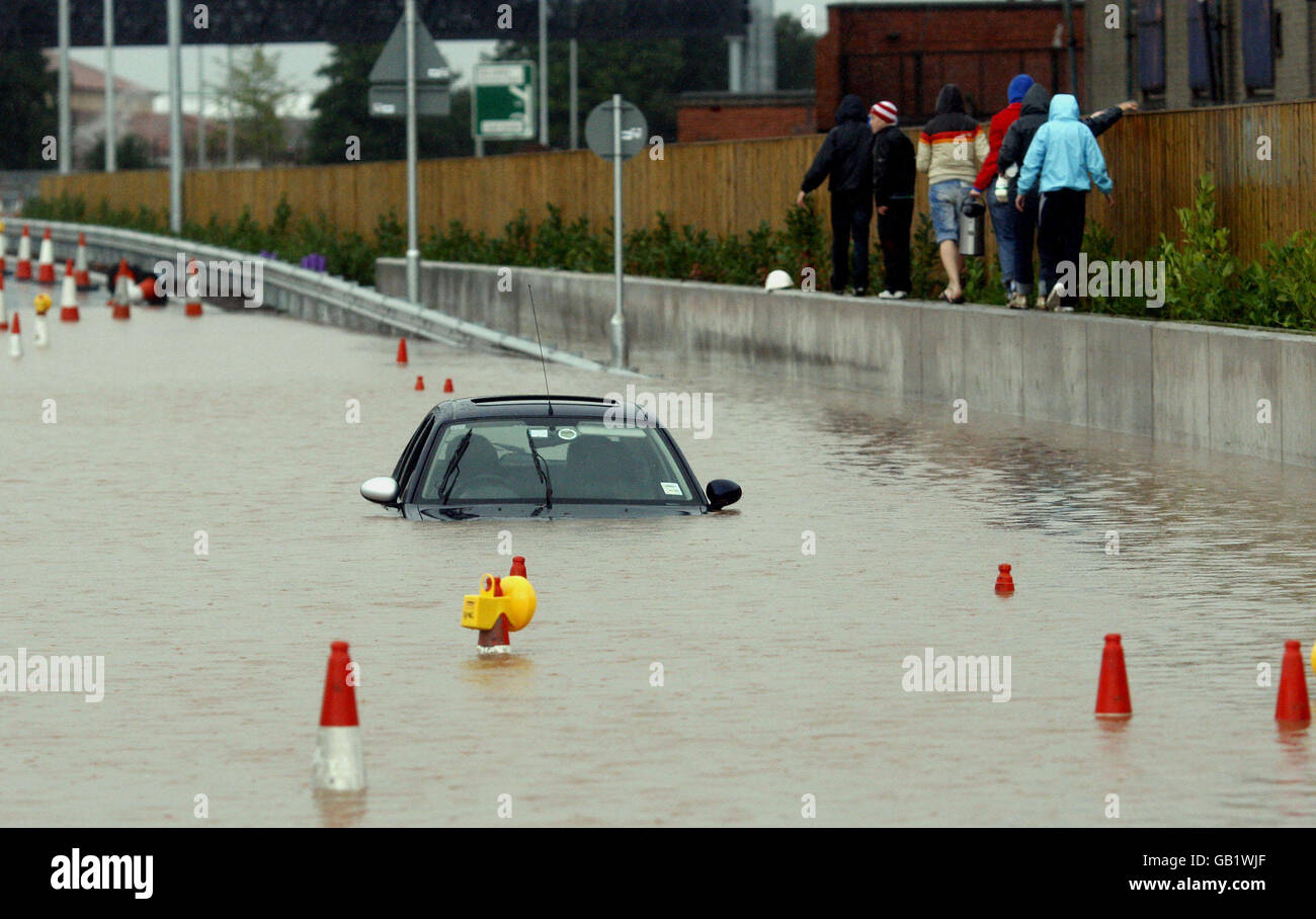 A motorist's car is abandoned after severe floods in the Westlink area of Belfast, Northern Ireland. Stock Photo