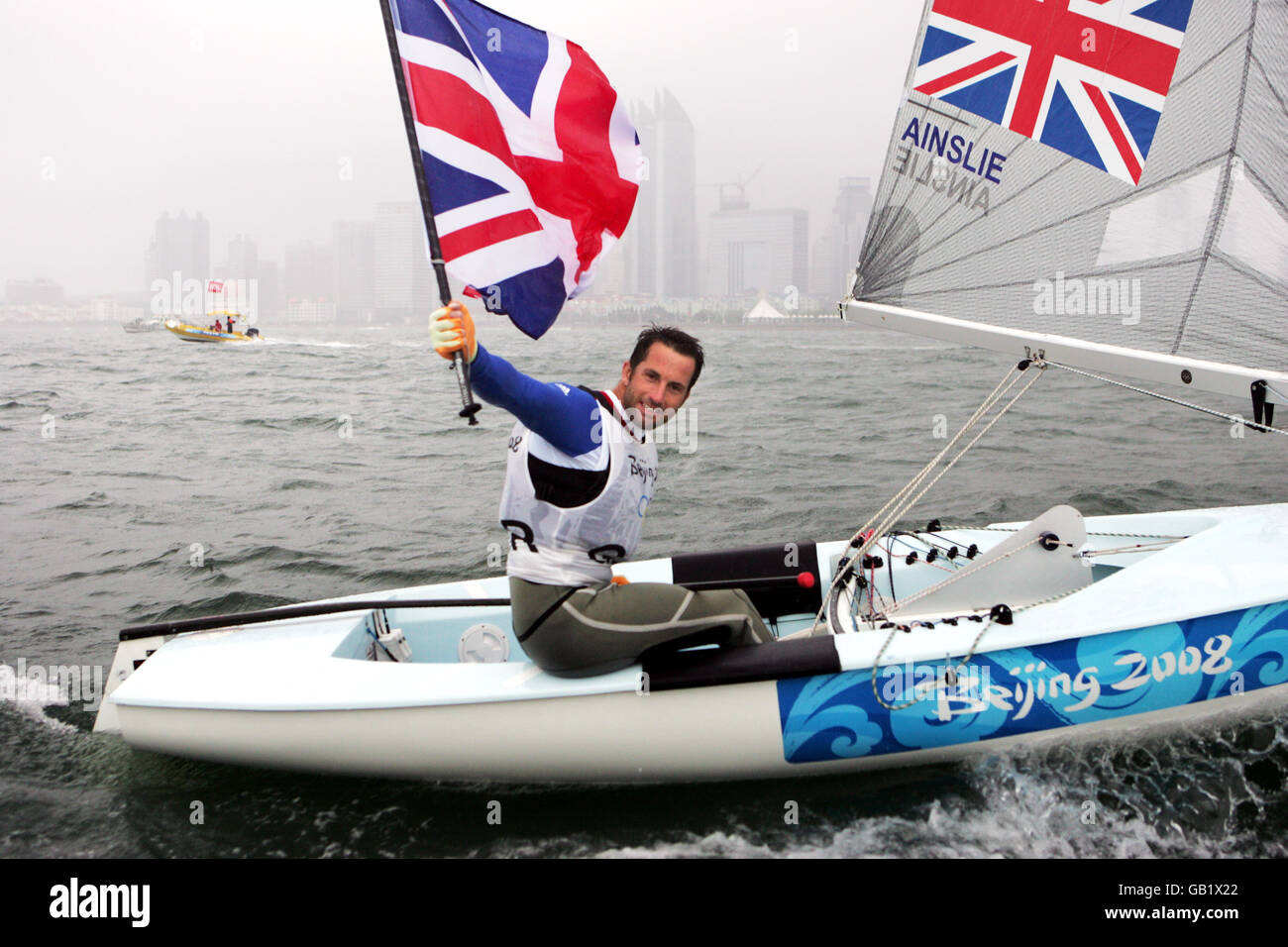 Great Britain's Ben Ainslie celebrates winning a gold medal in the Finn