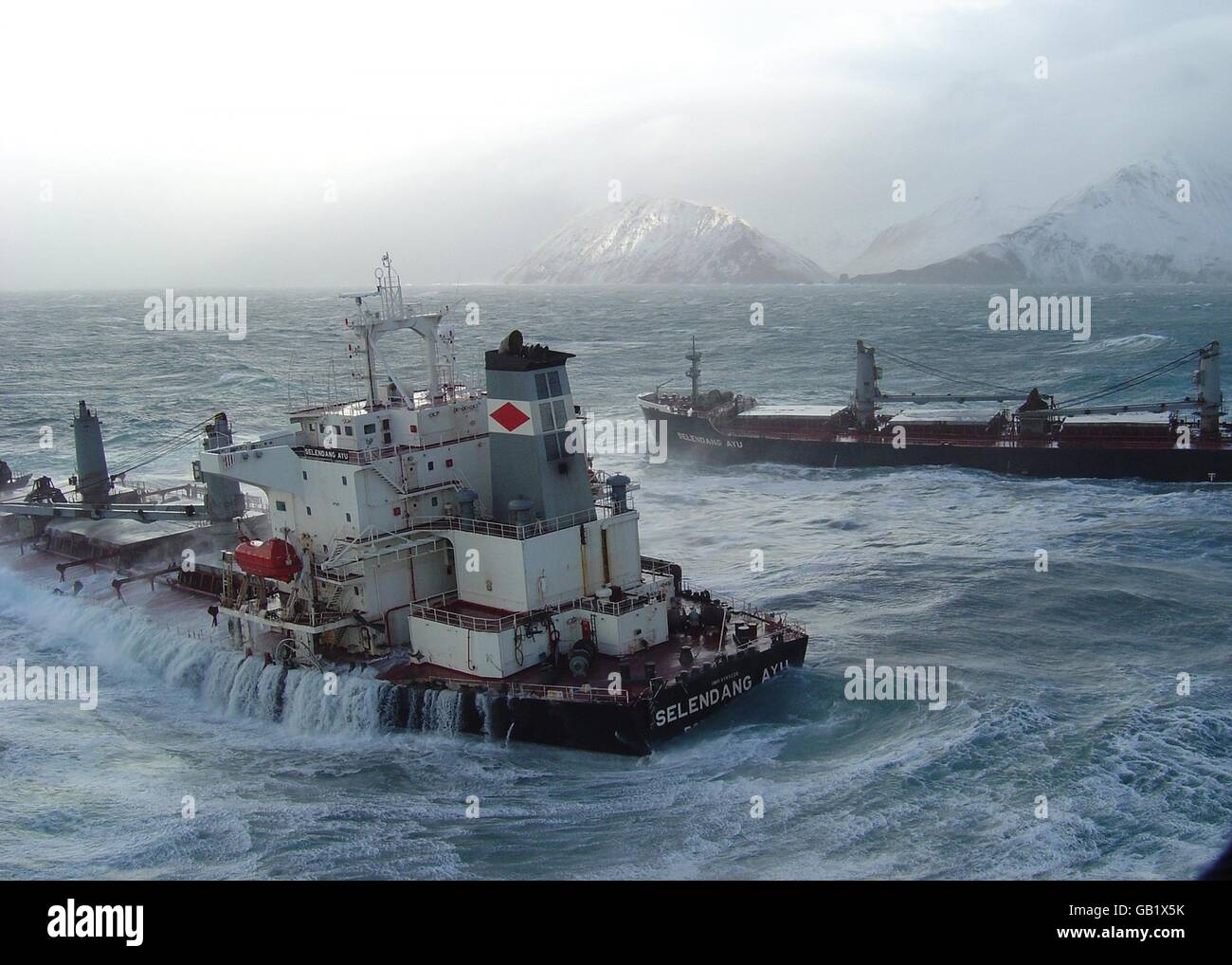 The M/V Selendang Ayu flounders on rocky shoals on the west side of Unalaska Island November 28, 2004 in the Aleutian Islands, Alaska. The vessel broke in two, releasing more than 337,000 gallons of petroleum fuel load of IFO-380 and marine diesel. Stock Photo