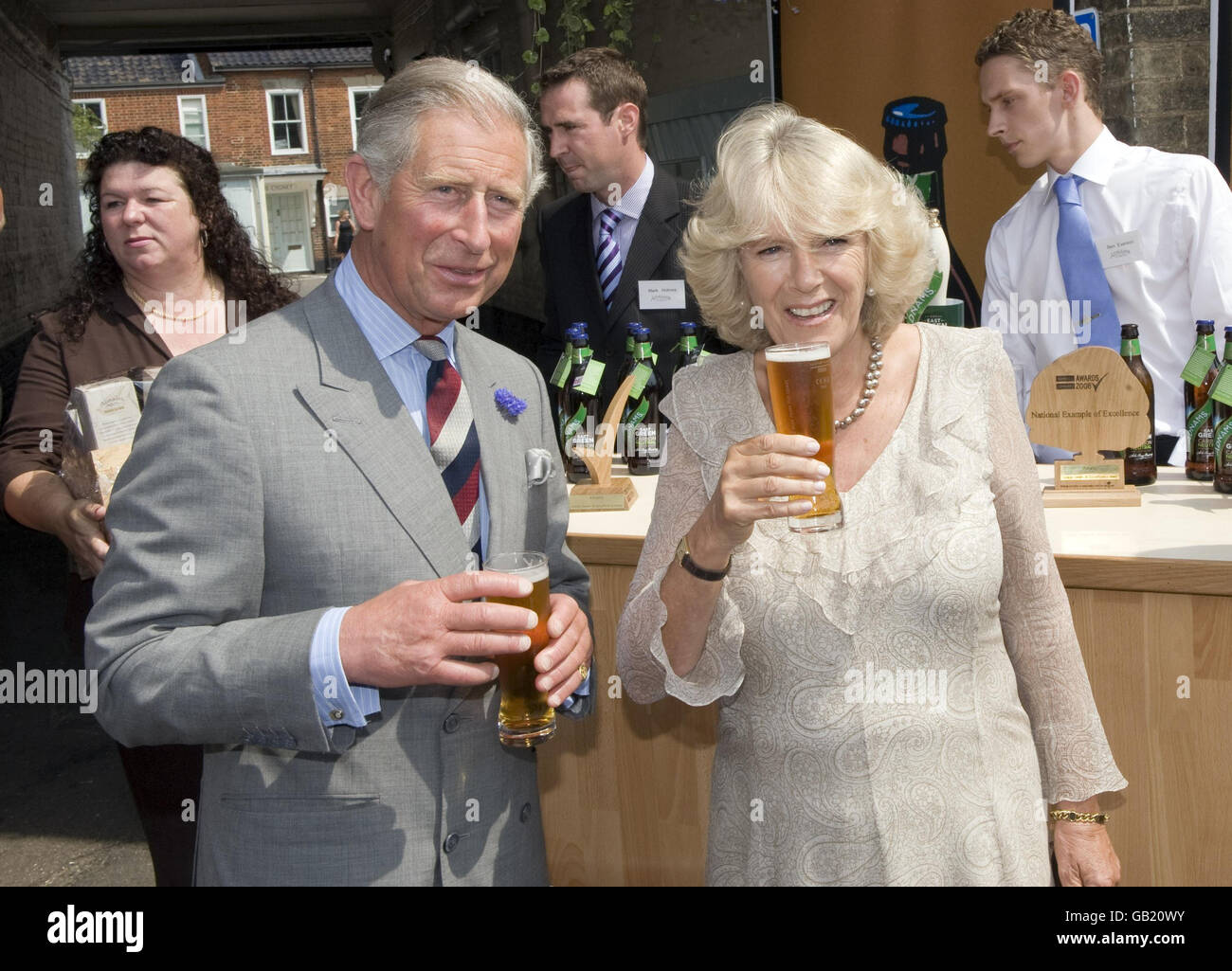 The Prince of Wales and Duchess of Cornwall sample some carbon neutral beer from Adnams Brewery, outside the Swan Hotel, as part of a tour of Southwold. Stock Photo