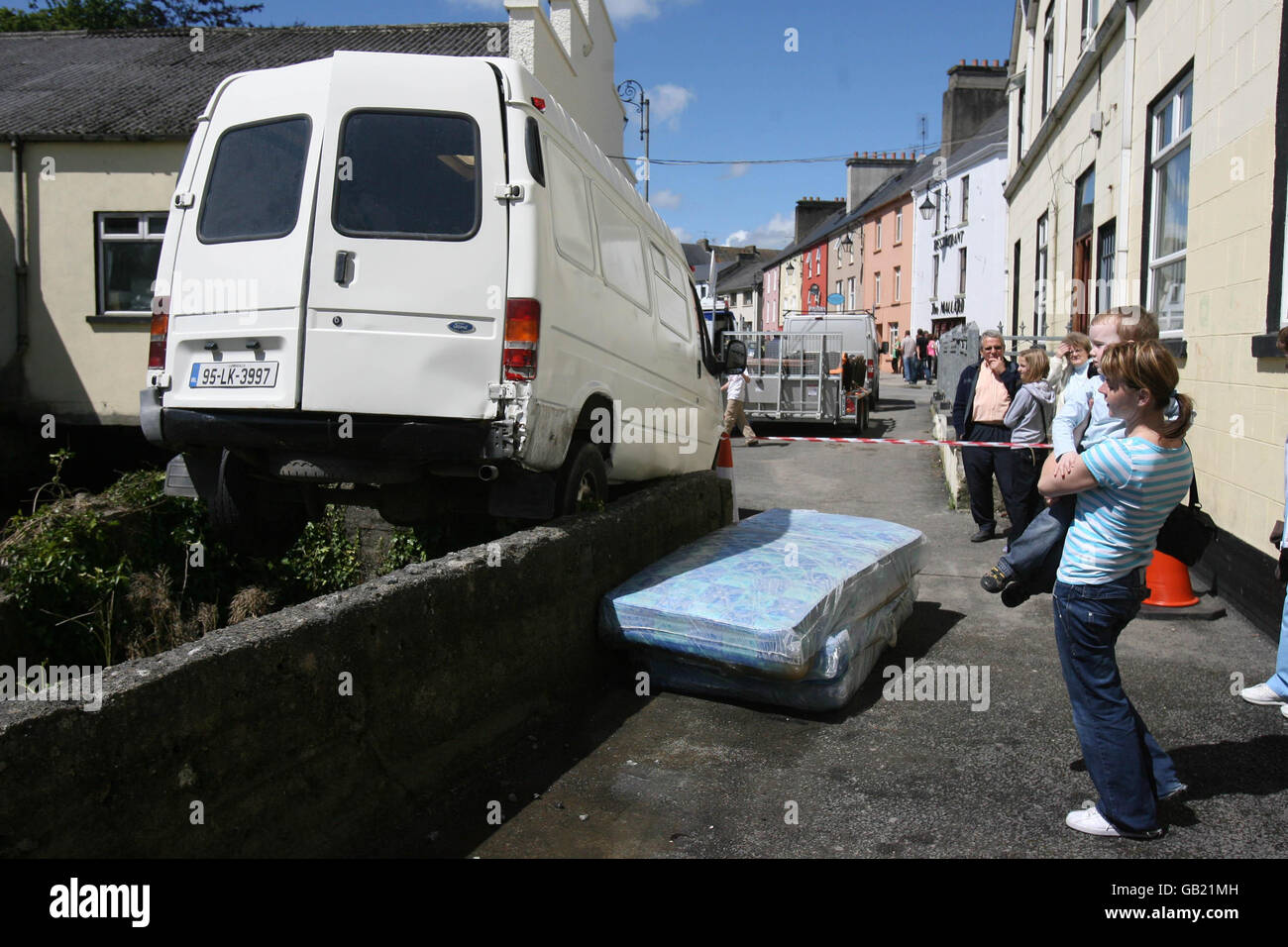 Local people look at a crashed van in Newcastle West, Co Limerick after