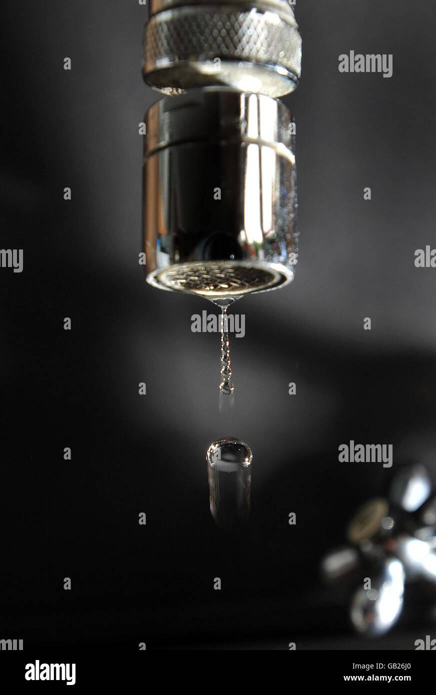 A general view of water dripping out of a kitchen tap. Stock Photo