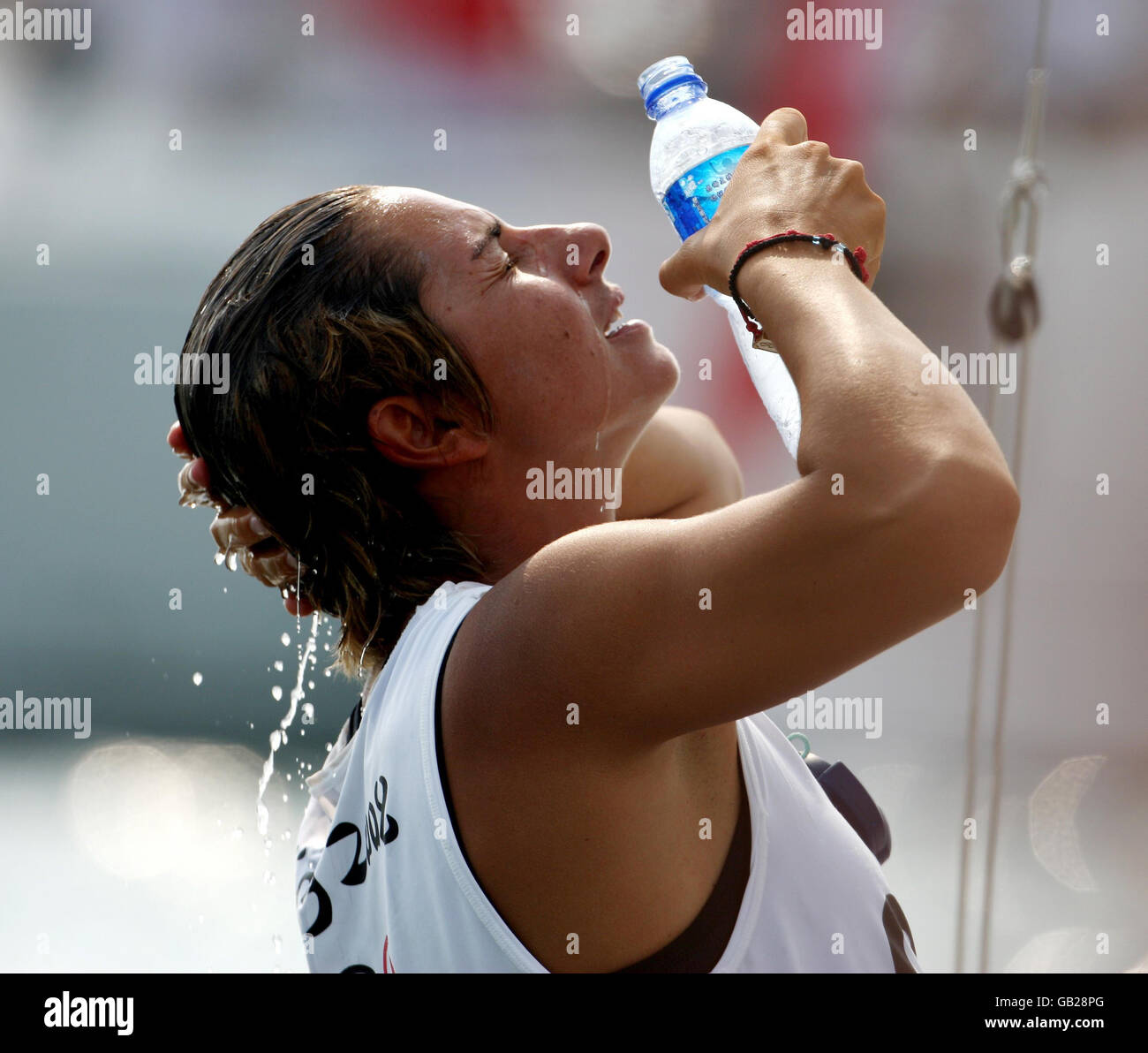 Greece's Yngling helm Sofia Bekatorou cools down in the windless heat as racing is delayed in the Beijing Olympic regatta off Qingdao, China. Stock Photo