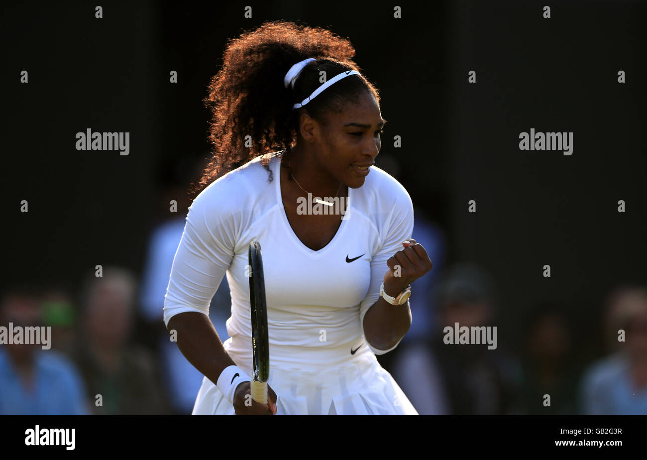 Serena Williams celebrates winning the first set during her doubles match with sister Venus Williams on day eight of the Wimbledon Championships at the All England Lawn Tennis and Croquet Club, Wimbledon. Stock Photo