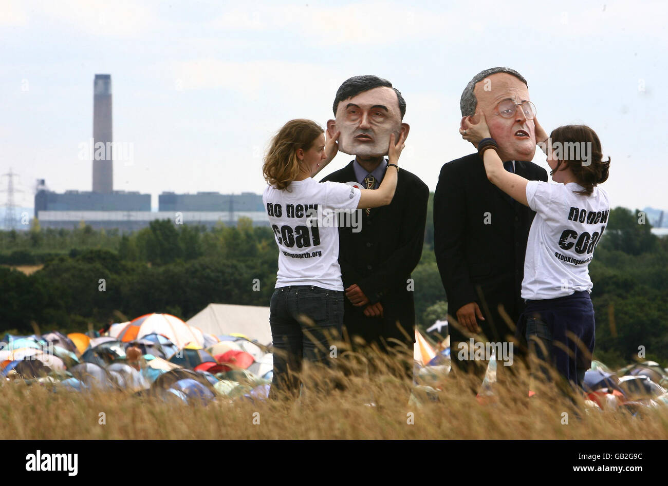 Caricatures of Prime Minister Gordon Brown (left) with Hilary Benn, Minister for the Environment, Food and Rural Affairs are prepared for a photocall at the Climate Camp near Kingsnorth Power Station in Kent, as campaigners protest against the redevelopment of the coal fired power station. Stock Photo