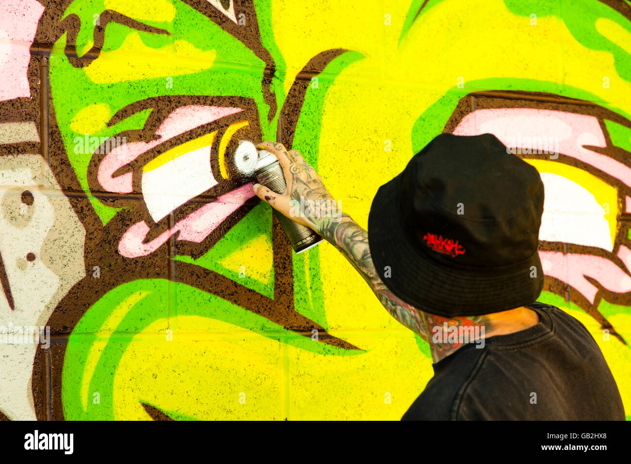 Brighton Graffiti artists painting a wall Stock Photo Alamy