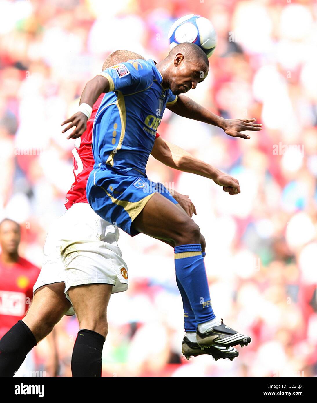 Portsmouth's Jermain Defoe and Manchester United's Nemanja Vidic battle for the ball in the air Stock Photo