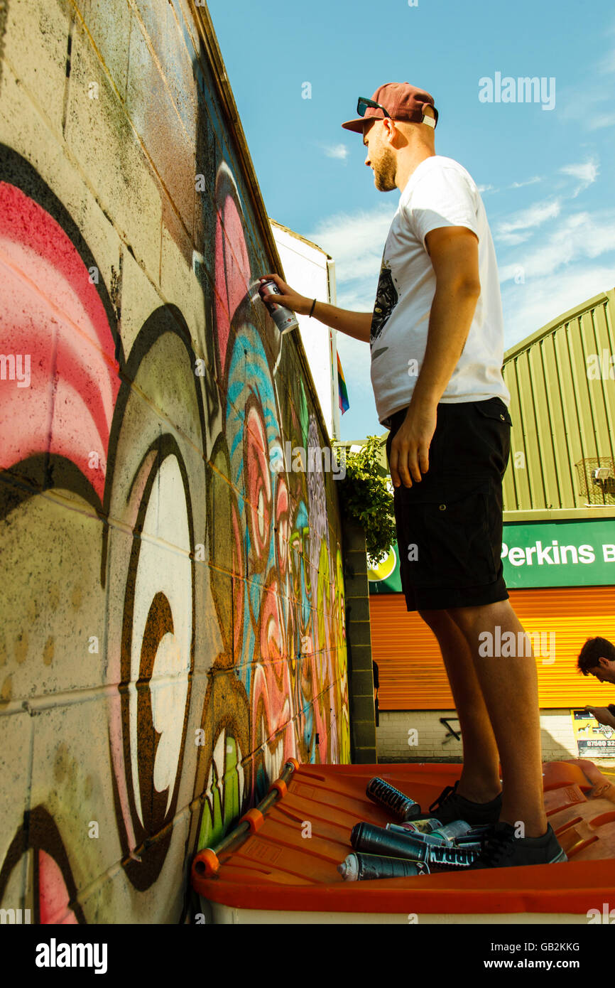 Brighton Graffiti artists painting a wall Stock Photo Alamy